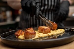 Prepared Scallops being plated